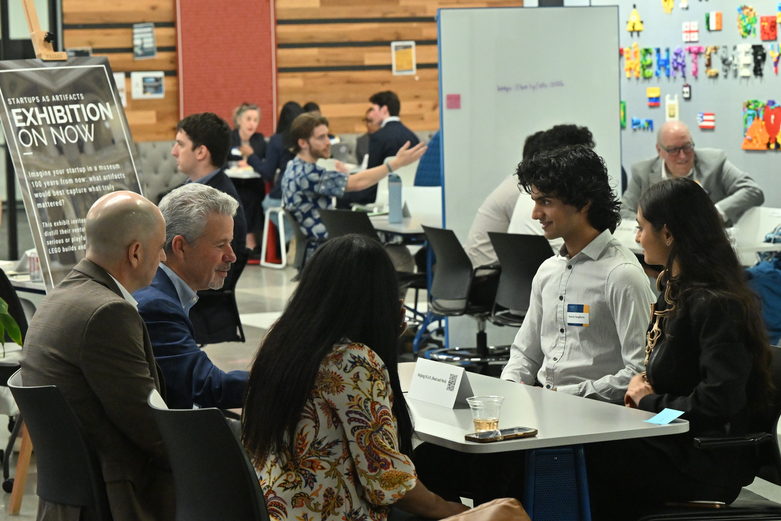 four students having a lively conversation in a study hall