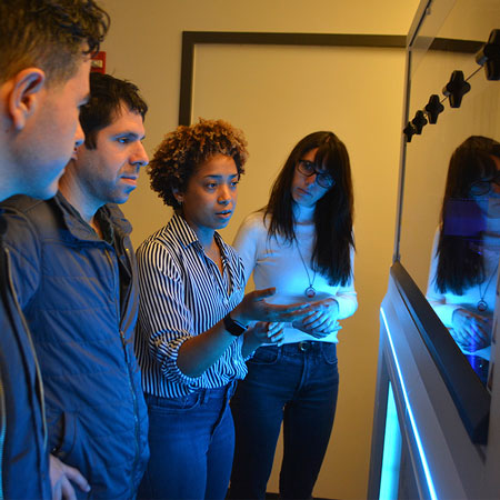 researchers looking at a cellxpress automated cell culture system