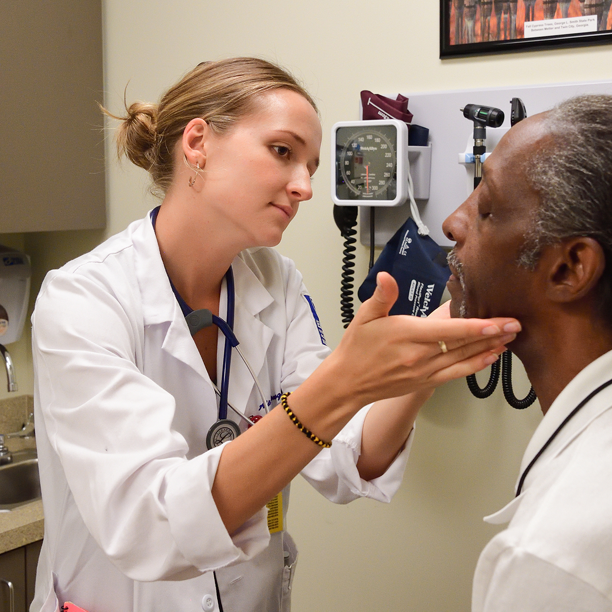 Doctor examining patient with device